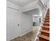 Well-lit staircase with wooden steps and tiled floors leading to a bright, open area at 2270 Emerald Dr, Jonesboro, GA 30236