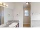 Bright bathroom vanity with granite countertop, sink, mirror with Hollywood lights, and a view to the walk-in closet at 4884 Antelope Cv, Atlanta, GA 30349