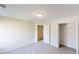 Bright bedroom with neutral carpet, ceiling light, closet, and doorway leading to another room at 4884 Antelope Cv, Atlanta, GA 30349