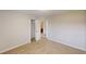 Bedroom with view to the walk-in closet, ensuite bathroom, and neutral carpet at 4884 Antelope Cv, Atlanta, GA 30349