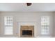 Elegant fireplace with brick surround and white mantel flanked by two windows, adding warmth and charm to the room at 4884 Antelope Cv, Atlanta, GA 30349
