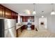 Stylish kitchen featuring stainless steel appliances, granite counters, cherry cabinets, and an open layout at 4884 Antelope Cv, Atlanta, GA 30349