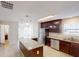 Modern kitchen with stainless steel appliances, granite countertops, a kitchen island and dark wood cabinets at 4884 Antelope Cv, Atlanta, GA 30349