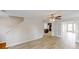 Open-concept living area with hardwood floors, a view of the kitchen, and a staircase, creating a spacious feel at 4884 Antelope Cv, Atlanta, GA 30349