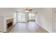 Spacious living room featuring hardwood floors, a cozy fireplace, and multiple windows offering plenty of natural light at 4884 Antelope Cv, Atlanta, GA 30349
