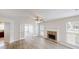 Bright living room with hardwood floors, fireplace, and French doors leading to another room filled with windows at 4884 Antelope Cv, Atlanta, GA 30349