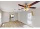 Neutral living area featuring a ceiling fan, white trim, and a back door, offering views into another room at 4884 Antelope Cv, Atlanta, GA 30349