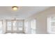 Bright living room filled with natural light through large windows with a ceiling fan for added comfort at 4884 Antelope Cv, Atlanta, GA 30349