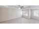 Spacious main bedroom with a tray ceiling, carpet, and natural light at 4884 Antelope Cv, Atlanta, GA 30349