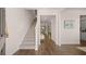 Inviting foyer featuring hardwood flooring, a staircase, and a seamless transition to the living spaces at 616 Kimberwick Dr, Locust Grove, GA 30248
