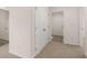 Bright hallway with neutral walls, featuring linen closet and access to various rooms throughout the house at 616 Kimberwick Dr, Locust Grove, GA 30248