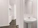 Convenient powder room with pedestal sink, off the entry foyer at 616 Kimberwick Dr, Locust Grove, GA 30248