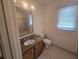 Bright bathroom featuring a granite-style vanity countertop, toilet, and hexagon tile flooring at 639 Royal Abbey Dr, Stone Mountain, GA 30088