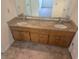 Bathroom vanity with double sinks and a granite countertop, offering plenty of storage at 639 Royal Abbey Dr, Stone Mountain, GA 30088