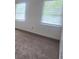 Bedroom with neutral carpet and two windows providing ample natural light at 639 Royal Abbey Dr, Stone Mountain, GA 30088
