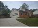 Two-story brick home featuring an attached garage, landscaped yard, and a well-maintained exterior at 639 Royal Abbey Dr, Stone Mountain, GA 30088