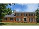 Traditional two-story brick home with black shutters, white trim, and manicured lawn at 639 Royal Abbey Dr, Stone Mountain, GA 30088
