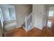 Inviting foyer with hardwood floors and a staircase leading to the upper level of the home at 639 Royal Abbey Dr, Stone Mountain, GA 30088