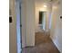 Hallway featuring neutral carpeting, white trim and multiple access doors at 639 Royal Abbey Dr, Stone Mountain, GA 30088