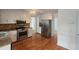 Well-lit kitchen featuring stainless steel appliances, granite countertops and beautiful hardwood flooring at 639 Royal Abbey Dr, Stone Mountain, GA 30088