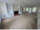 Spacious living room with fireplace, built-in bookshelves, and natural light at 639 Royal Abbey Dr, Stone Mountain, GA 30088