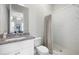 Bathroom showcasing a granite countertop vanity and a tiled shower with a glass door at 217 Napa Dr, Woodstock, GA 30188