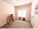 Bright bedroom with pink walls, neutral carpet, and a doll house at 217 Napa Dr, Woodstock, GA 30188