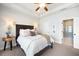 Well-lit bedroom has a dark wood headboard and side tables and an attached bathroom at 217 Napa Dr, Woodstock, GA 30188