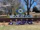 Welcome to Downtown Woodstock sign surrounded by colorful flowers and lush greenery under a bright sky at 217 Napa Dr, Woodstock, GA 30188