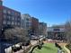 View of the community buildings with a restaurant and lawn seating at 217 Napa Dr, Woodstock, GA 30188