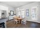A dining area with hardwood floors, a chandelier, stainless steel appliances, and outdoor access at 217 Napa Dr, Woodstock, GA 30188