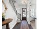 Inviting entryway with hardwood floors, a staircase, a decorative rug, and a wooden front door at 217 Napa Dr, Woodstock, GA 30188