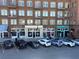 Brick building featuring commercial spaces like Eden and Bizarre, with cars parked along the sidewalk at 217 Napa Dr, Woodstock, GA 30188