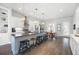 Gourmet kitchen with stainless steel appliances, island seating, modern pendant lights, and hardwood flooring at 217 Napa Dr, Woodstock, GA 30188