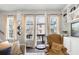 Sun-filled living area with multiple windows, cozy seating, and built-in shelving providing ample storage at 217 Napa Dr, Woodstock, GA 30188
