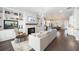 Open-concept living room featuring a fireplace, built-in shelving, and seamless flow into the modern kitchen and dining area at 217 Napa Dr, Woodstock, GA 30188