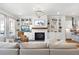 Spacious living room with a fireplace, built-in shelving, and an open view into the modern kitchen at 217 Napa Dr, Woodstock, GA 30188
