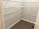 Walk-in pantry with dark floor and white, wire shelving for organized storage space at 217 Napa Dr, Woodstock, GA 30188