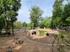 Playground featuring natural elements like rock tunnels, climbing structures, and surrounded by lush trees at 217 Napa Dr, Woodstock, GA 30188