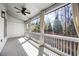 Covered porch with a ceiling fan, white railings, and a view of the wooded backyard at 217 Napa Dr, Woodstock, GA 30188