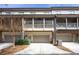 Rear exterior of townhomes showing garages and screened in patios on the second story at 217 Napa Dr, Woodstock, GA 30188