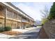 Rear exterior of townhomes showing garages and screened in patios on the second story at 217 Napa Dr, Woodstock, GA 30188