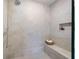 Walk-in shower with built-in bench and wall niche; neutral color and mosaic tile floor at 217 Napa Dr, Woodstock, GA 30188