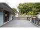 A view of the back deck with modern railings overlooks the backyard and features a sliding glass door at 2274 Edgemore Se Dr, Atlanta, GA 30316