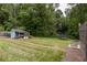 An expansive backyard features green grass, a storage shed, a trampoline, and garden beds at 2274 Edgemore Se Dr, Atlanta, GA 30316