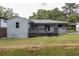 An expansive backyard view featuring a house with a large deck and a covered parking area at 2274 Edgemore Se Dr, Atlanta, GA 30316