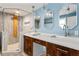 A bathroom featuring a walk-in shower, double vanity with marble countertop, and modern light fixtures at 2274 Edgemore Se Dr, Atlanta, GA 30316