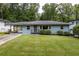 Charming single-story home featuring a well-maintained lawn and covered parking at 2274 Edgemore Se Dr, Atlanta, GA 30316