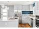 Bright kitchen features a stainless steel refrigerator, island with cooktop, and blue backsplash at 2274 Edgemore Se Dr, Atlanta, GA 30316