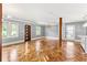 Bright and spacious living room showcasing beautiful herringbone hardwood floors and ample natural light at 2274 Edgemore Se Dr, Atlanta, GA 30316